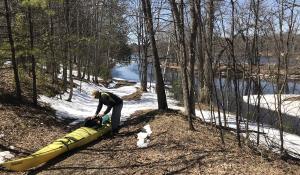 man pulls kayak out of Menominee offshoot
